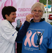 Denise Sylvest (physiotherapist, Castlegar & District Hospital) applies a pink ribbon tattoo to Mary Hatlevik (retired RPN, Kootenay Boundary Regional Hospital).