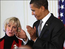 President Obama applauds Lilly Ledbetter