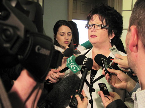 photo of nsgeu president Joan Jessome in a reporter's scrum