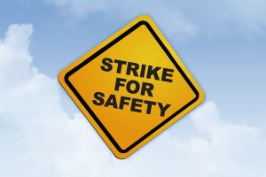 Yellow caution sign saying #strikeforsafety